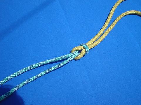 The reef knot can be tied easily by following this instructional video.